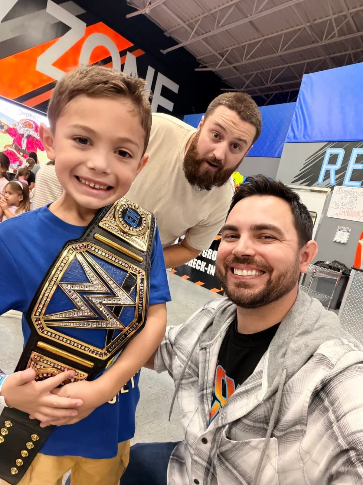 Wrestlers wearing championship belts